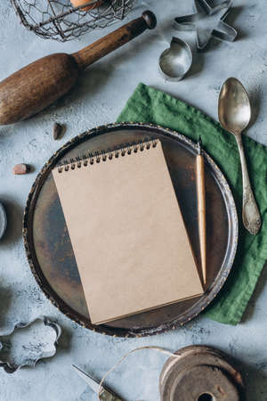 recipe book mockup on kitchen table with kitchen utensils in vintage styleの写真素材