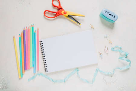 Flat lay composition with notebook and stationery on light background. Space for textの写真素材
