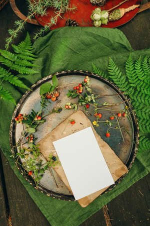 Rustic rustic table setting with empty card and wildflowers, top viewの写真素材
