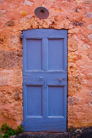 a typical colored door of a house of provenceの写真素材