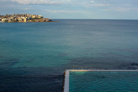 a landscape of bondi beach where a swimming pool merges with the seaの写真素材