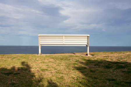 a bench watching the ocean near bondi beachの写真素材