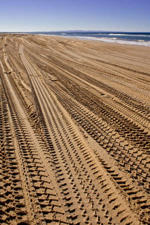 Australians are used to pass through rainbow beach with a jeep and then stop to enjoy the sun, leaving many tracesの写真素材