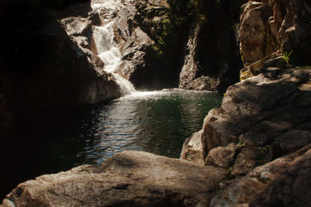 a waterfall becomes a small lake in the forestの写真素材