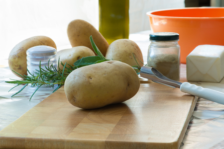 Roasted potatoes, ingredients to Achieve them (ingredients - salt, rosemary, sage, oil, butter, spices)の写真素材