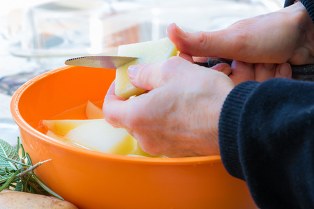 Preparing roast potatoesの写真素材