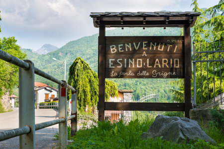 Esino Lario, Italy - May 27, 2016: tourist sign at the entrance of the village. The sign says: "Welcome to Esino Lario the pearl of the Grigne." Esino Lario, venue between 21 to 28 June 2016 of the 12th international Wikimedia conference, is a small mountのeditorial素材