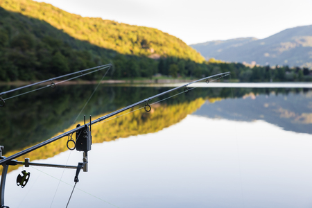 Fishing Adventures - Fishing tackle (Bite alarm, rod pod, fishing rod) for fishing with the technique of carp on blurred backgroundの写真素材