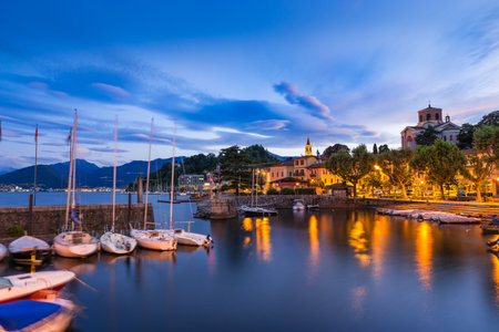 Lake Maggiore, Laveno, north Italy. View at sunrise of the beautiful small and old harbor and of the lakeside promenade of Laveno, province of Vareseのeditorial素材