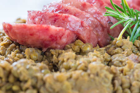 Cotechino (pork sausage) with lentils. Traditional Italian dish.  According to tradition, it is served with lentils on New Year's Eve, because it is said that lentils bring money for the coming yearの写真素材