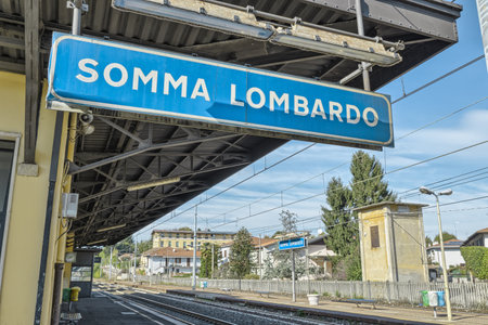 Somma Lombardo train station, town in the province of Varese, Lombardy, Italy, about 50 km (31 mi.) from Milan city. Focus on the foreground signのeditorial素材