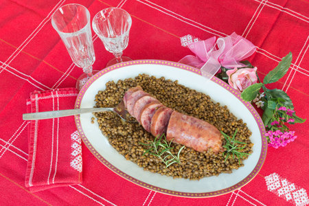 Cotechino (pork sausage) with lentils. Traditional Italian dish.  According to tradition, it is served with lentils on New Year's Eve, because it is said that lentils bring money for the coming yearの写真素材