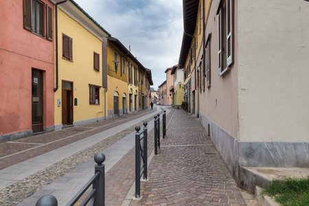 Picturesque street with classic stone paving and porphyry cubes in northern Italy. Center of Arese city and street G. Matteiの写真素材