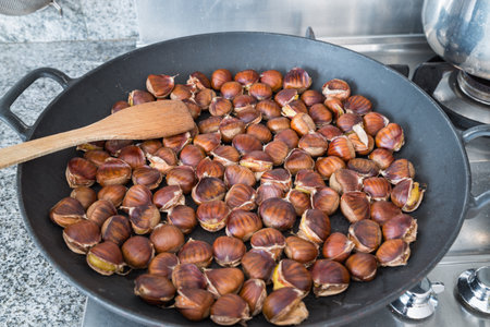Roasted chestnuts cooked in a pan at home. Sweet chestnut (Castanea sativa). Selective focusの写真素材