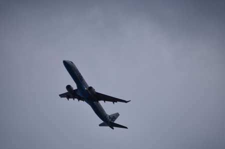 Blue and White Commercial Airplane Flying Upwards