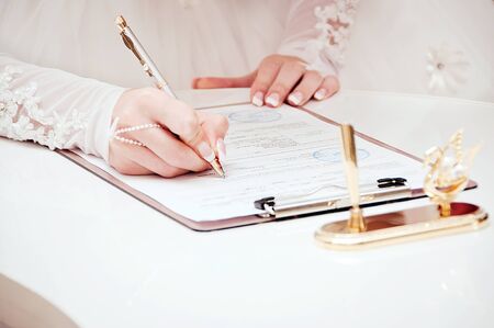 Newly-married couple signs documentsの写真素材