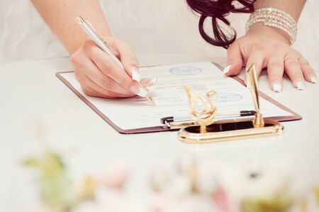 Newly-married couple signs documentsの写真素材