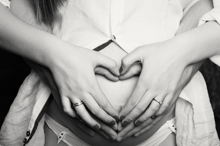 Pregnant young woman with man in studioの写真素材