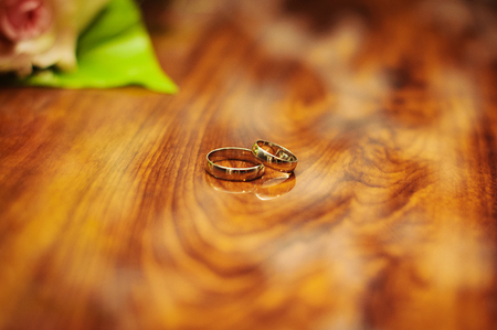 A pair of golden wedding rings layered on each other.の写真素材