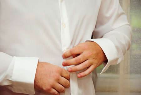 Business man tidy up his suit's buttonの写真素材