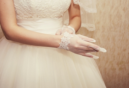 beautiful bride puts on a white gloveの写真素材