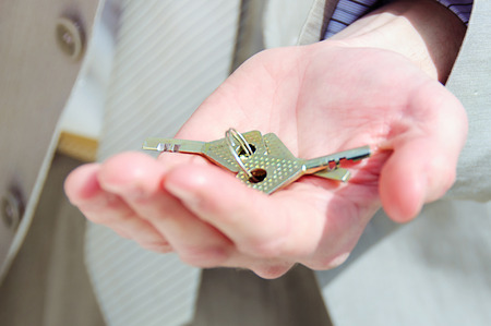 Two keys from the lock in hands at the manの写真素材