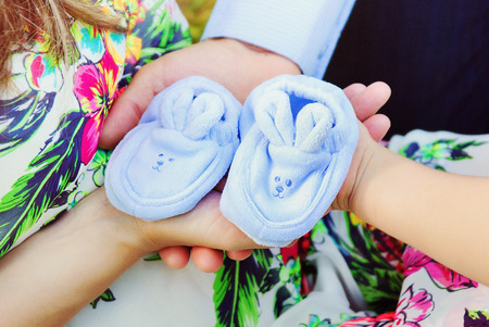 Newborn baby booties in parents handsの写真素材