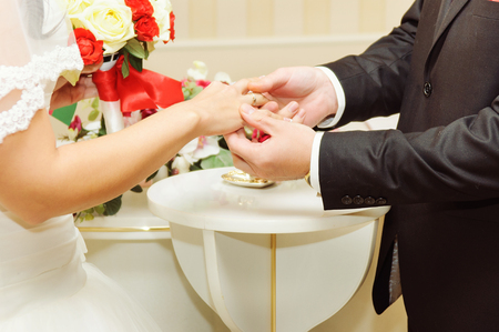 Wedding couple exchanging the ringsの写真素材