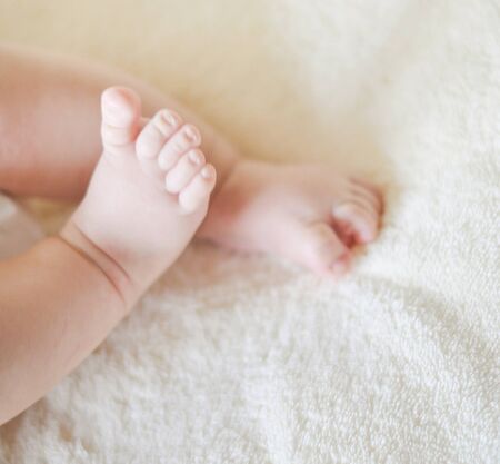 Close up of the baby charming legsの写真素材
