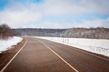 beautiful winter landscape with road and snow-covered treesの写真素材