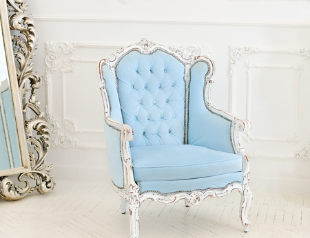 vintage luxury armchair in blue tones in white roomの写真素材