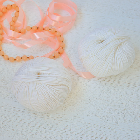 top view of colored yarn balls and knitting needles