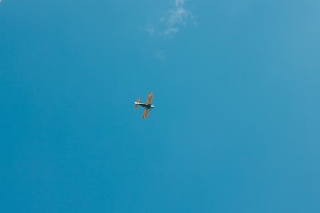 sun and cumulus white clouds against a beautiful blue sky, fly plane