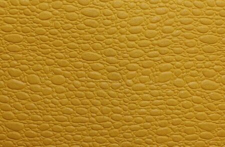 Imitation of dark yellow snake skin, artificial texture.の写真素材