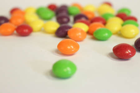 Bright, colored candies on a white background