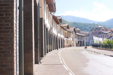 Wall of the house with arches along the road