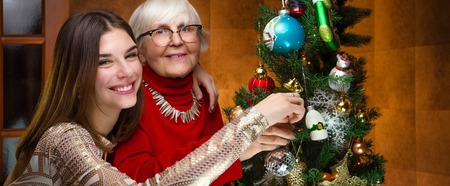 new year. senior grandma and young caucasian woman, teenagerの写真素材