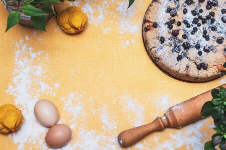 composition on a yellow background from eggs, pie and chickensの写真素材