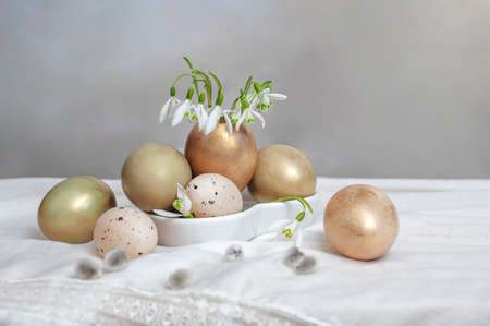 composition of eggs and snowdrops on the background of a tablecloth. Country style.