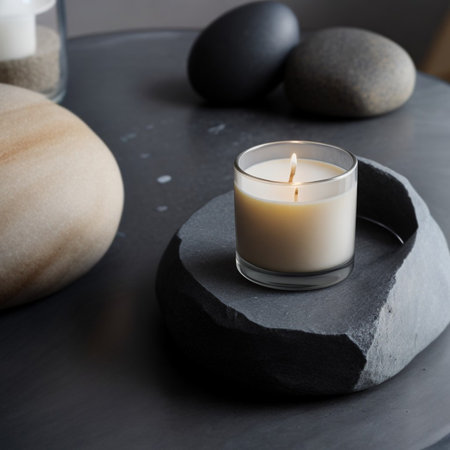 Close-up of a burning wax candle standing on a decorative gray stone. Generative AI.の素材