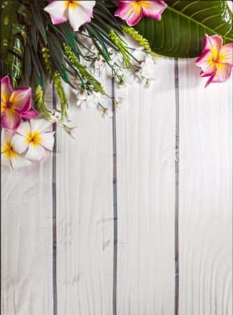 Tropical flowers on a white wooden background. Empty space for text. Generative AI.の素材