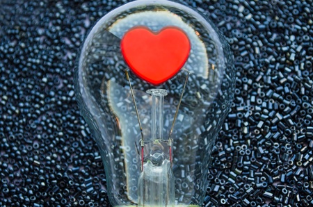 Love concept - red heart of an electric bulbの写真素材