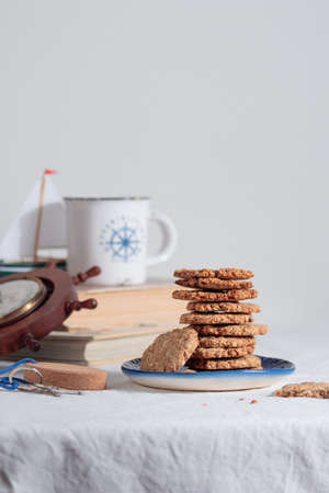 Cup of coffee with cookies in a sailing style on a tableの写真素材