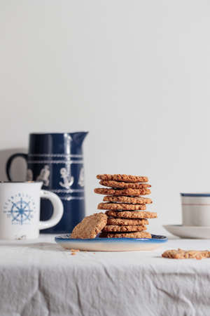 Cup of coffee with cookies in a sailing style on a tableの写真素材