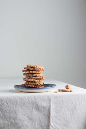Stack of homemade oat cookies on a tableの写真素材