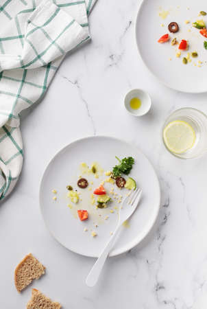 Empty dirty white plate with Vegetable Salad top view