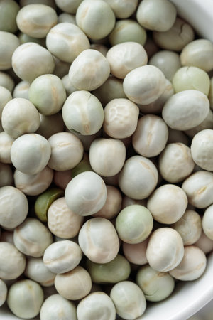 Raw Dried Green Peas in a white bowl on a tableの写真素材