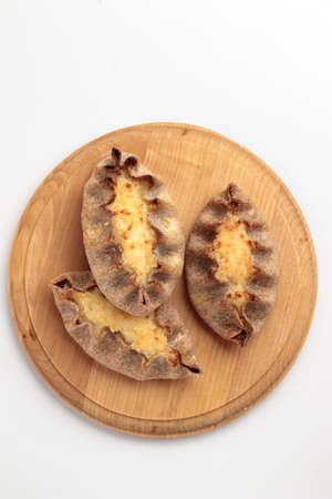 Traditional Finnish pastry - Karelian rye pie with rice porridge and on a table top view