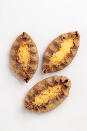 Traditional Finnish pastry - Karelian rye pie with rice porridge and on a table top viewの写真素材