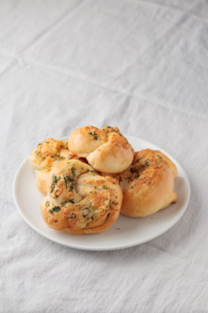 Homemade pastry - buns with parsley and cheese on a white tableの写真素材